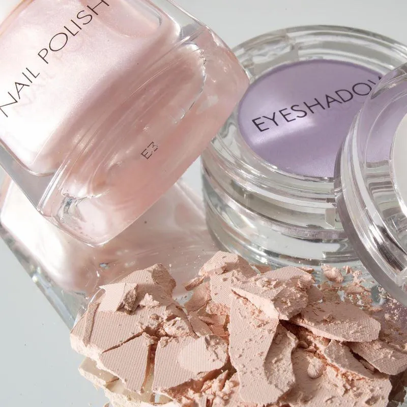 Pink nail varnish and purple eyeshadow cosmetics with inkjet product coding